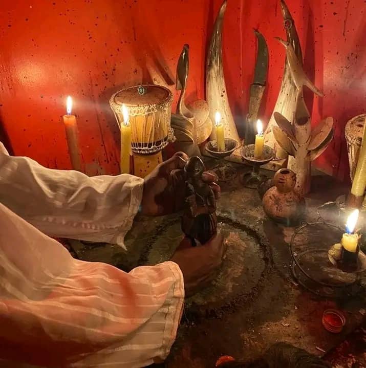 Candles, carved figures and horns on Chief Miamambo's red ritual altar
